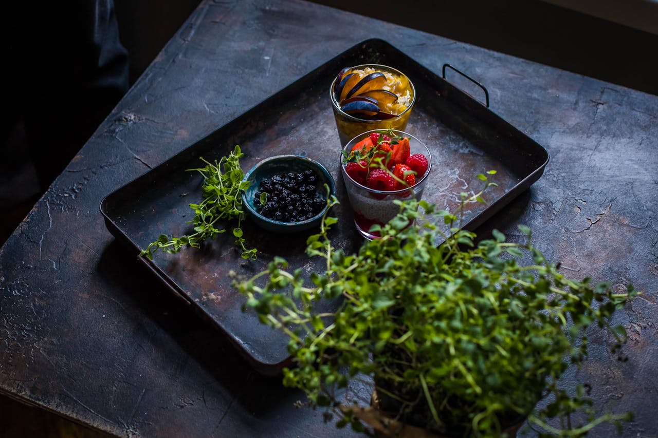 Fresh fruits with herbs on a rustic tray, perfect for healthy eating.