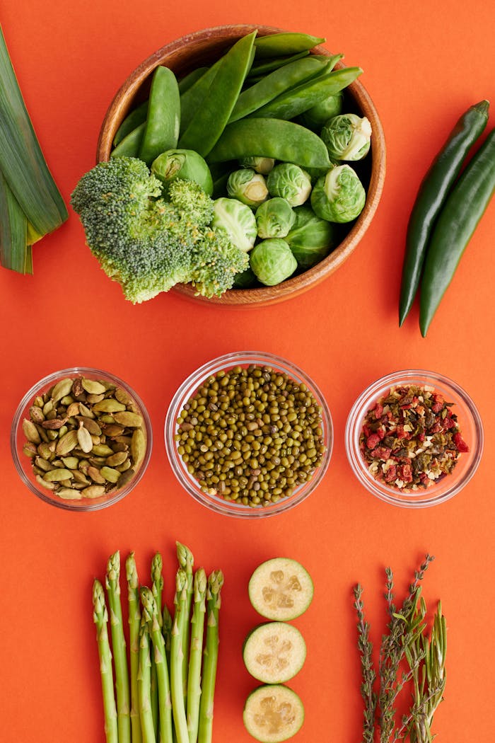 Crafting Captivating Headlines: Your awesome post title goes here Colorful array of vegetables and spices on an orange backdrop, featuring beans and greens.